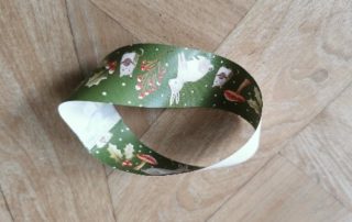 Make a Möbius strip by twisting one end of the strip before joining together.